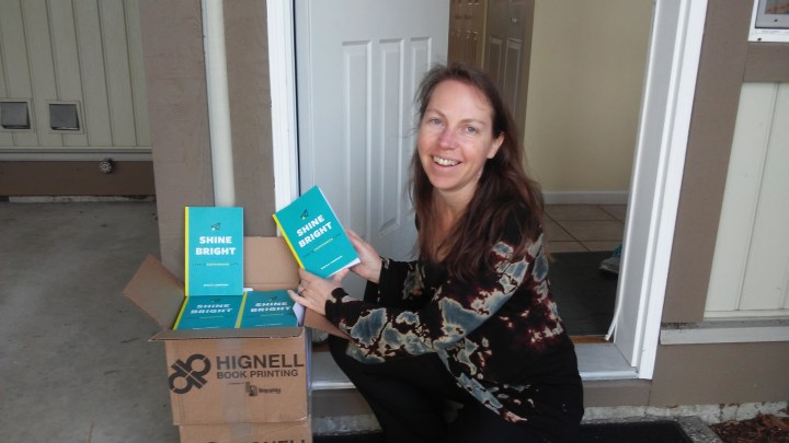Sheila opening box of first shipment of books