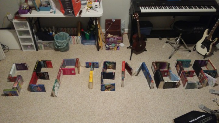 September spelled using books balanced on page edges