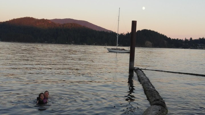 Sheila and Simon swimming in ocean at sunset